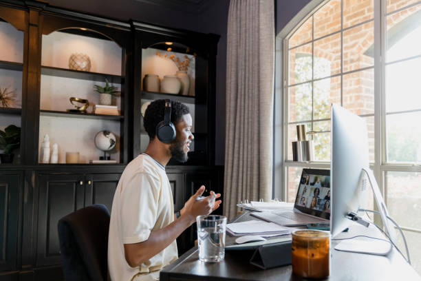 istock Young adult man leads virtual meeting 1455343093