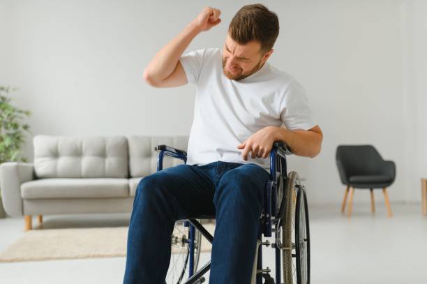 istock Young sad man in a wheelchair at home 1455343363
