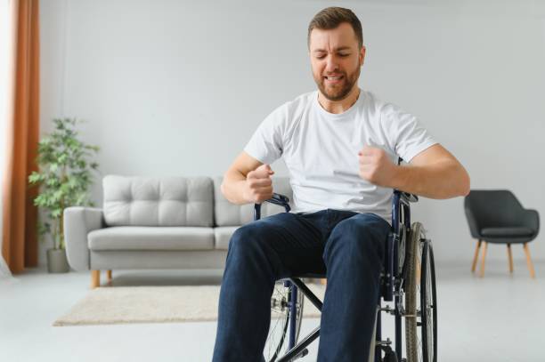 istock Capable disabled trying to get up from the wheelchair. 1455343366