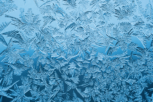 Ice background. Copy space. Frost pattern on glass. Cold weather.