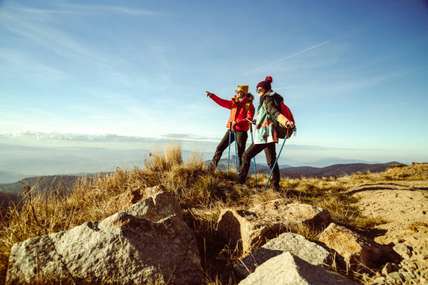 istock Two female hikers enjoying the view from mountain peak on a nice sunny day 1455346878