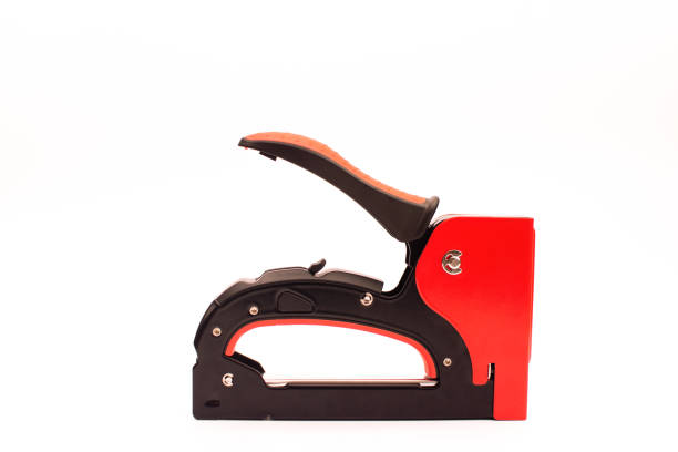 red Industrial stapler isolated on white background.