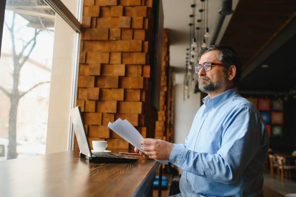 istock man in casual form using mobile phone at the cafe 1455349254