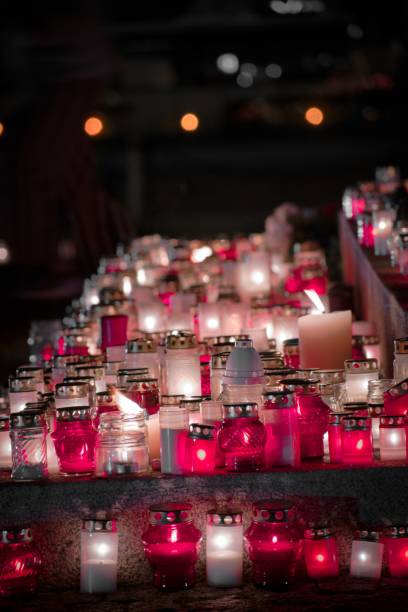 istock Vertical shot of candles arranged next to each other on a stone surface 1455352897