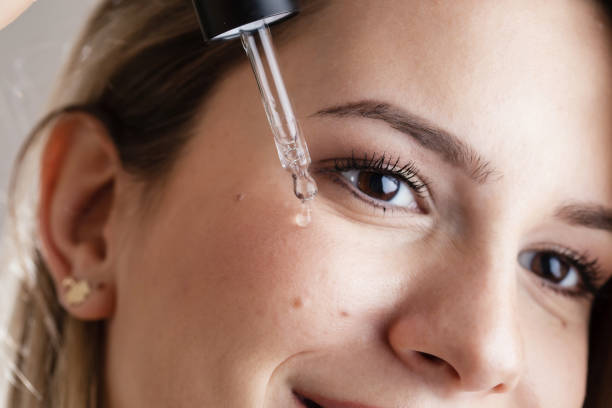 istock Woman Applying Serum 1455355540