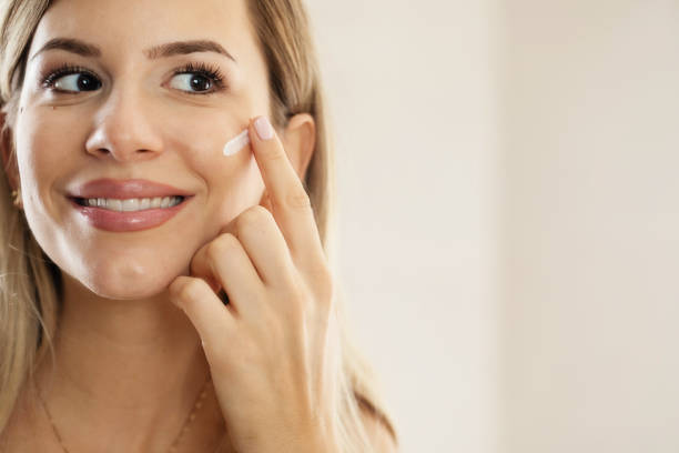 istock Woman Putting Face Cream 1455355558