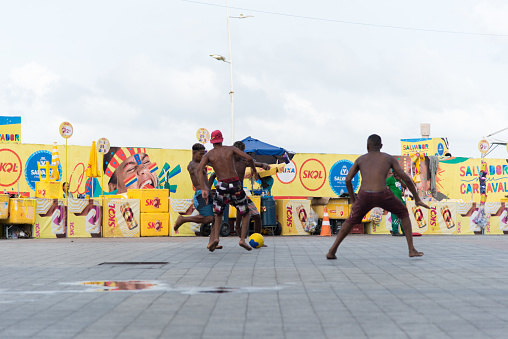 Salvador, Bahia, Brazil - February 09, 2018: Young beer sellers playing ball after Carnival night in Salvador, Bahia.