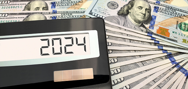 New year 2024. Calculator and US dollars. Trends, prospects and hopes