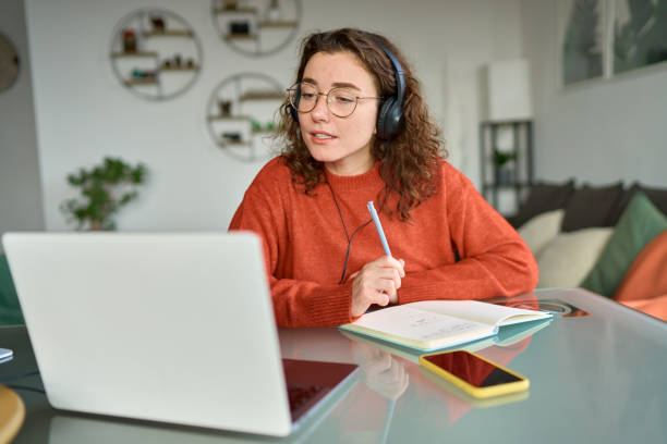 istock Young woman student elearning online on laptop computer at home. 1455363905