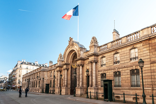 Facade entrance of the Elysée palace, the official residence of the  president french Republic in Paris, Rue Saint Honoré. Sunny weather, with French flag flying. Paris in France. November 18th, 2022.