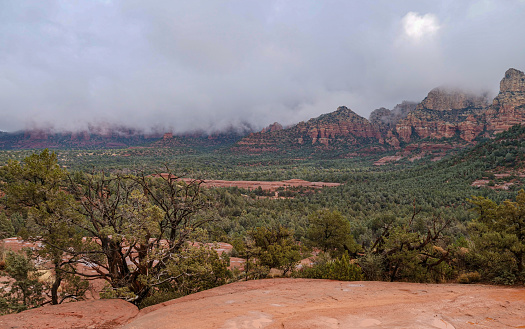 Sedona, Arizona after a winter rain.  Hazy day with low clouds on the red rock mountains
