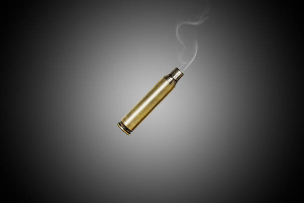 istock Smoking bullet assault rifle 5.56 casing shell fired out of a assault rifle falling down 1455367556