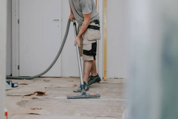 istock A young man vacuums the floor with a construction vacuum cleaner. 1455368649