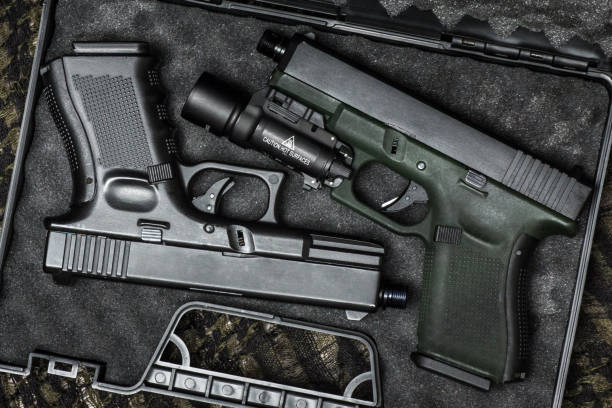 istock Glock 19 gen4 and gen5 model, Glock polymer pistol and popular handgun weapon with flashlight attachment olive green color and black. 1455369620