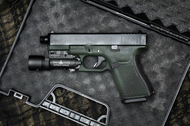 istock Glock 19 gen4 and gen5 model, Glock polymer pistol and popular handgun weapon with flashlight attachment olive green color and black. 1455369842