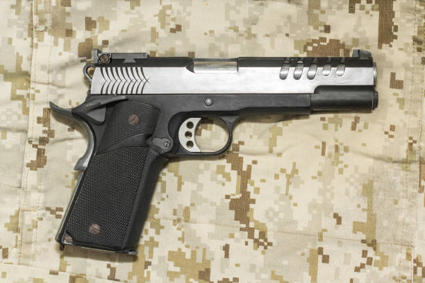 istock M1911 pistol weapon on Marine Desert camo 1455369912