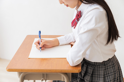 asian girl who study ,hands,School uniform,School classroom
