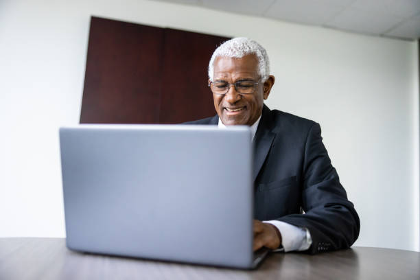 istock Senior black businessman executive using a laptop in conference room 1455373116