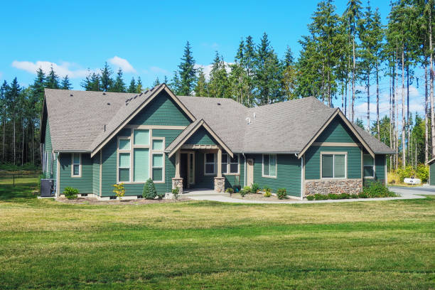 Luxury Single Story Home Exterior Surrounded by Trees stock photo