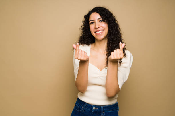 istock Attractive young woman making korean hearts 1455374828