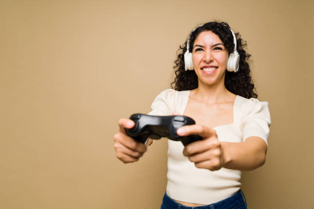 istock Beautiful woman gaming having fun 1455374873