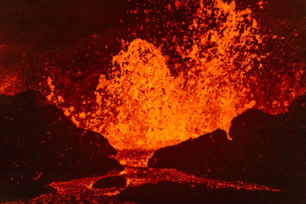 The Meradalir volcano in Iceland erupting, sending fountains of glowing orange lava, and flowing into a lava river.