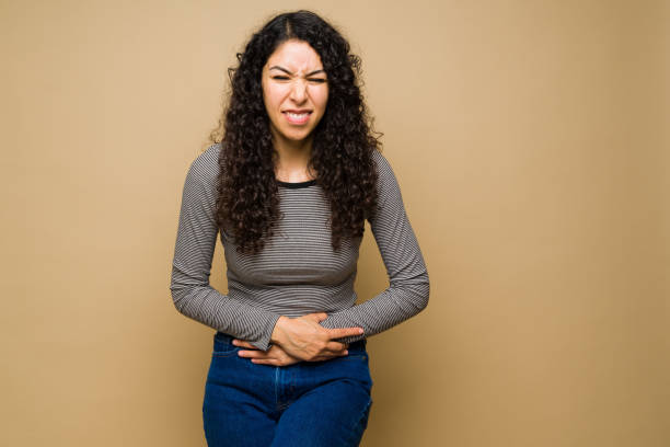 istock Upset young woman having bad cramps 1455377275