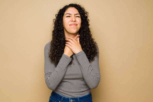 istock Sick young woman with a sore throat 1455377295