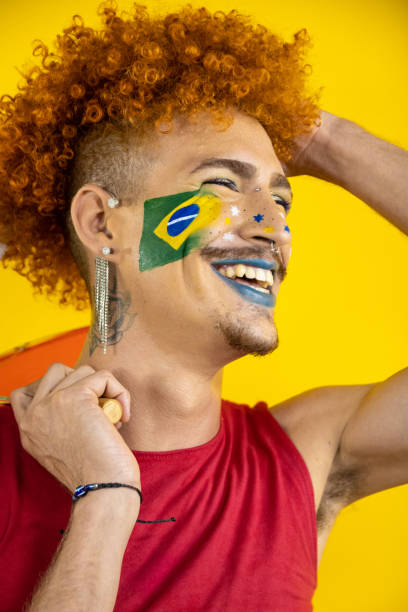 Portrait of non-binary man on yellow background