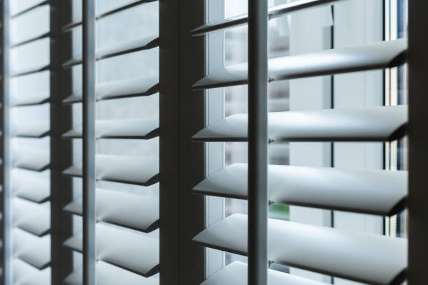 istock wooden white blinds on the window close-up 1455380439