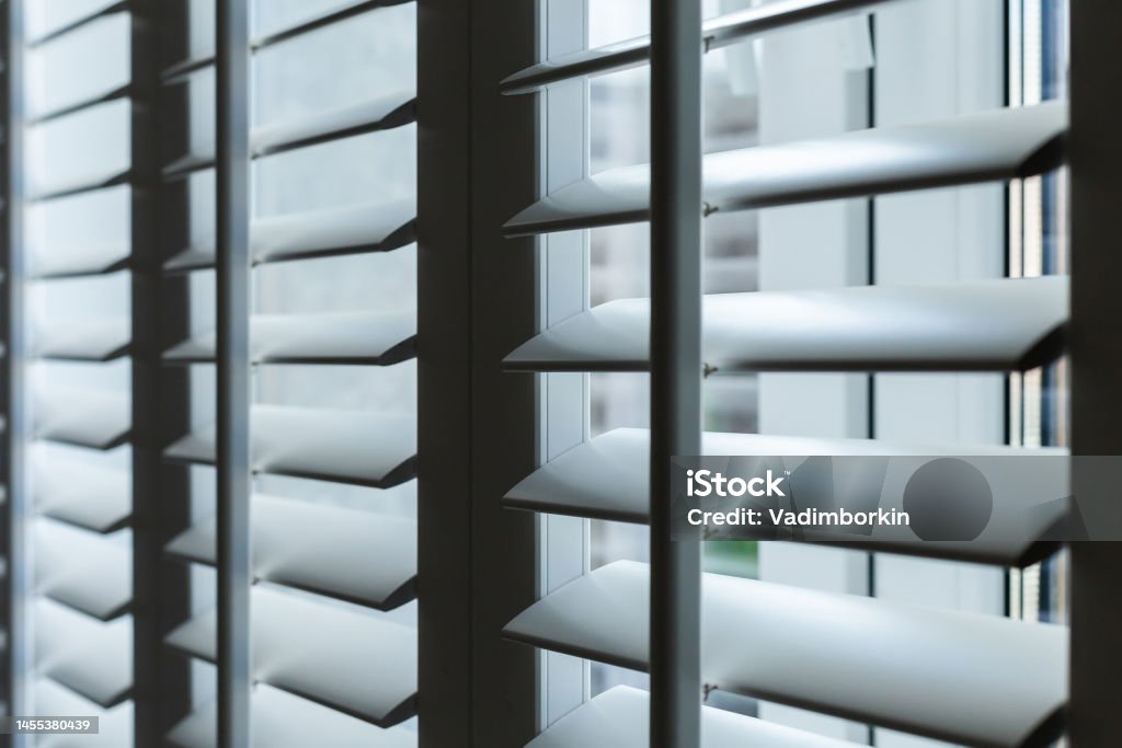 wooden white blinds on the window close-up Shutter Stock Photo