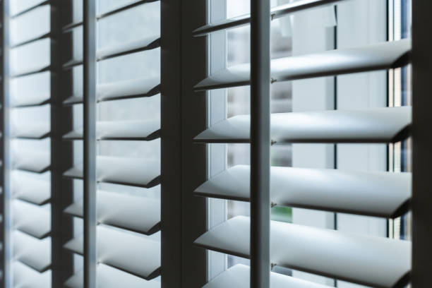 wooden white blinds on the window close-up wooden white blinds on the window close-up shutter stock pictures, royalty-free photos & images