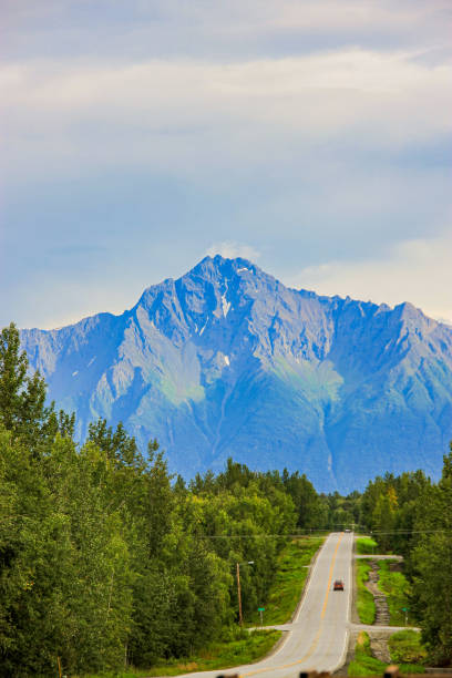 two lanr road leading to mountain with car
