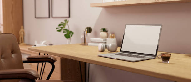 istock Minimal home workspace with laptop mockup and accessories on wood table 1455383398
