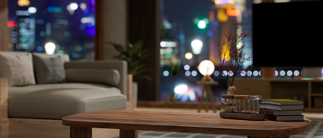 Copy space for montage your product display on wood coffee table in modern contemporary apartment living room at night with city night lights in the background. 3d rendering, 3d illustration