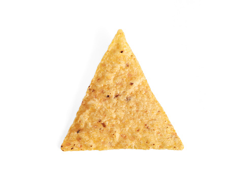 Top view of one yellow triangle corn chip on white background. Mexican salty snack used for appetizer with salsa, tomato sauce, cheese or vegetables.