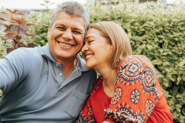 Married couple having a happy time Married couple having a happy time in their backyard 50 59 years stock pictures, royalty-free photos & images