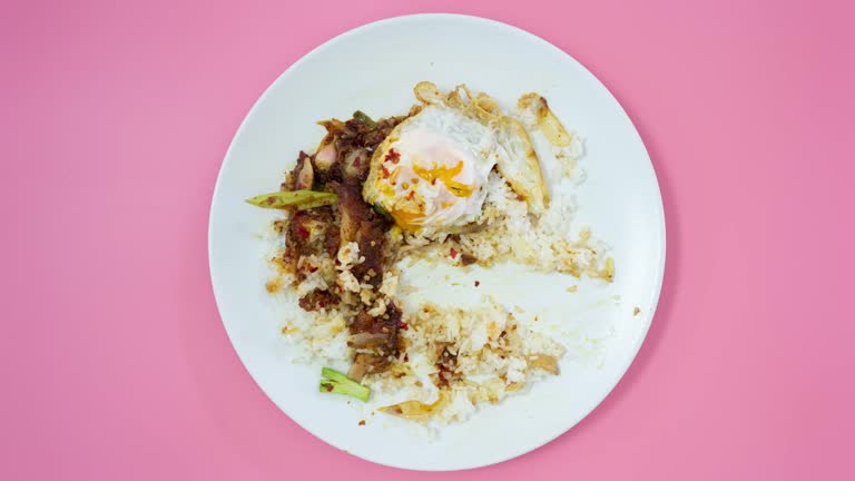 Stop motion animation, Eating rice in white plate on pink background.