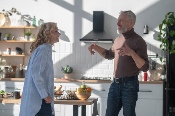 istock Mature couple having morning coffee andtalking in the kitchen 1455387086