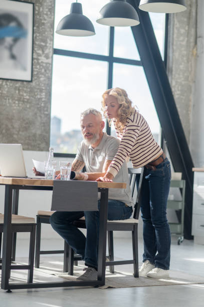 istock Two people at the laptop looking involved and discussing something 1455387175