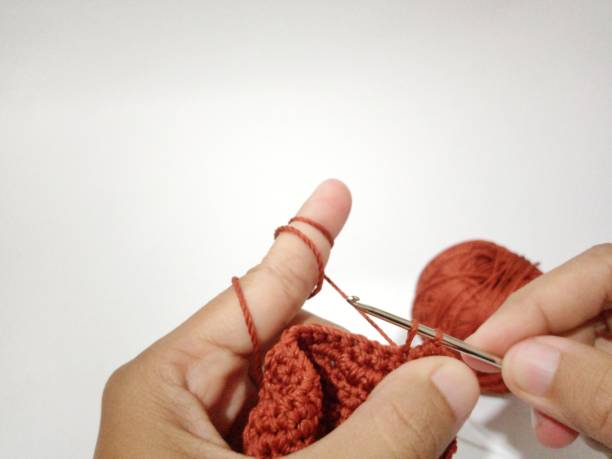 istock Close-up of knitting hands 1455387817