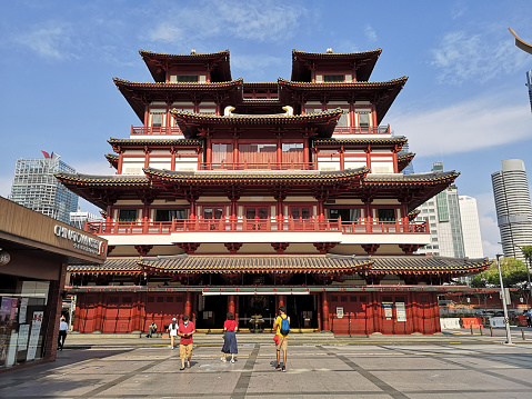 Tourists outside the Buddha Tooth Relic Temple and Museum, a Buddhist temple and museum complex located in the Chinatown district of Singapore. Built in 1870 and gazetted as a national monument of Singapore in 2014, it is one of Singapore's oldest temples.