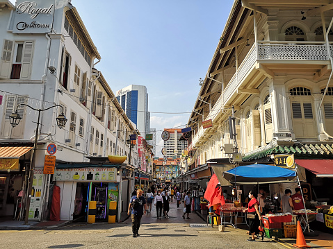 People walking at the busy Chinatown street market in downtown Singapore.