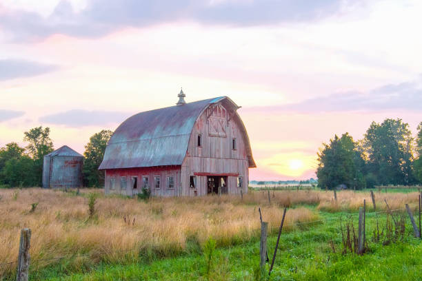 Old Weathered Red Barn at sunrise-Howard County, Indiana stock photo
