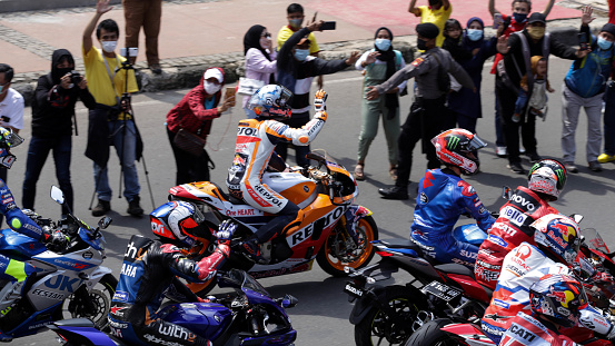 MotoGP racers greet fans who have gathered at a number of places crossed by the MotoGP parade in DKI Jakarta, Wednesday, March 16, 2022.
