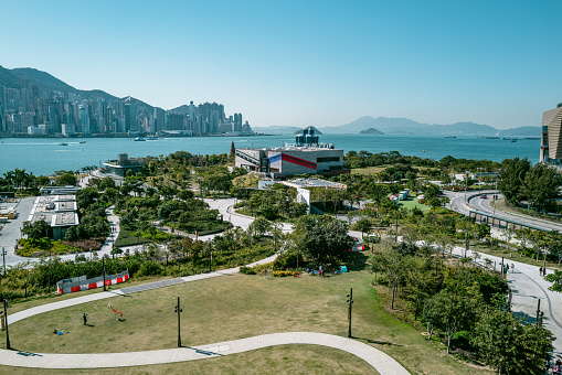 Hong Kong, December 20th 2022: locals and tourists enjoying sunshine, local landscape and daily life at West Kowloon Cultural District in HongKong, which is one of the busiest and most popular travel destinations in the world.