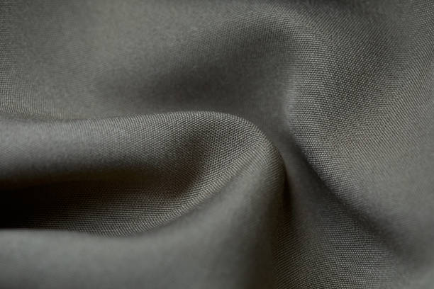 istock Grey fabric background. Grey cloth waves background texture. Grey fabric cloth textile material. 1455393986