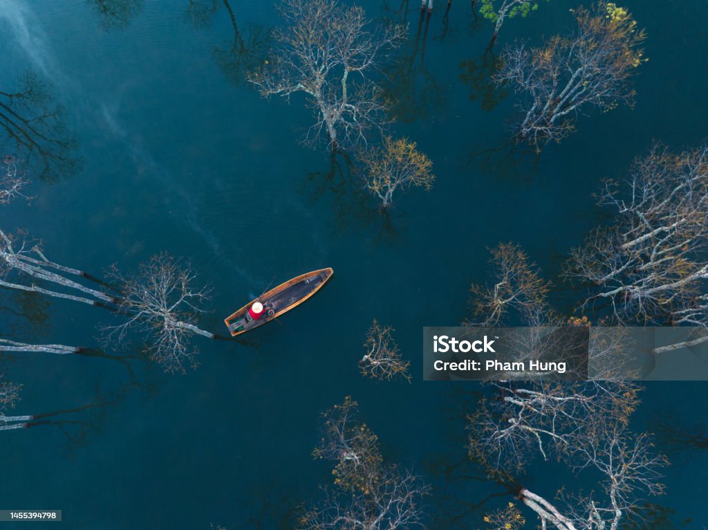 Drone view fisherman in Tuyen Lam lake Drone view fisherman in Tuyen Lam lake in a foggy morning, Da Lat city, Lam Dong province, central high lands Vietnam Landscape - Scenery Stock Photo