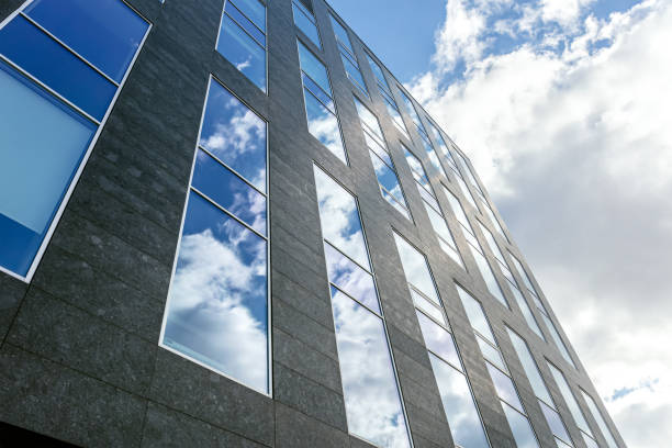 istock modern office building. glass facade with cloudy sky reflections. contemporary urban architecture. 1455394984