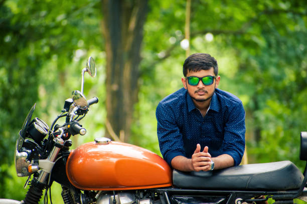 istock Handsome model posing on bike, with beautiful forest background. 1455397002
